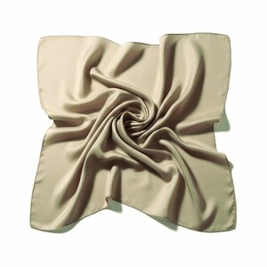 May include: A square, beige silk scarf with a swirling, folded design. The scarf has a smooth, lustrous texture and a subtle sheen. The edges are neatly finished, and the overall look is elegant and refined.