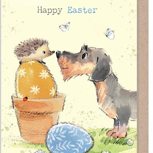 May include: Easter card illustration with a dachshund and a hedgehog. The hedgehog is perched on a decorated egg in a pot. A blue egg with a leaf pattern lies on the grass. The words "Happy Easter" are written in blue above the characters. Butterflies are also present.