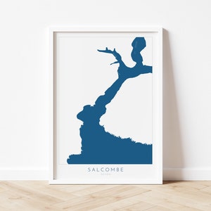 May include: A white framed print of a blue silhouette of Salcombe, Devon.
