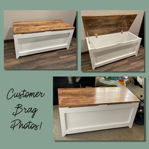 May include: A white wooden storage bench with a brown wood top. The lid is open to reveal the empty storage space inside. The bench is sitting on a wood floor.