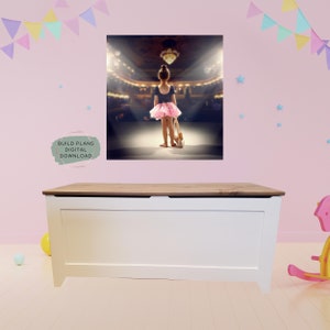 May include: A white toy chest with a wooden top. The chest is in a room with pink walls and a picture of a young girl in a pink tutu standing on a stage.