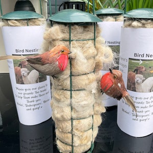 Alpaca wool filled bird feeder for nesting birds, green metal wire fat ball dispenser stuffed with alpaca fleece.