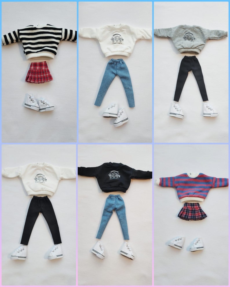 May include: Six different doll outfits with a variety of tops, bottoms, and skirts. The outfits include a striped sweater, a white sweater with a graphic, a gray sweater with a graphic, a black sweater with a graphic, a white sweater with a graphic, and a striped sweater. The bottoms include black leggings, blue jeans, and a plaid skirt. The outfits are all paired with white sneakers.