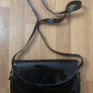 Cartouchière patent leather crossbody bag