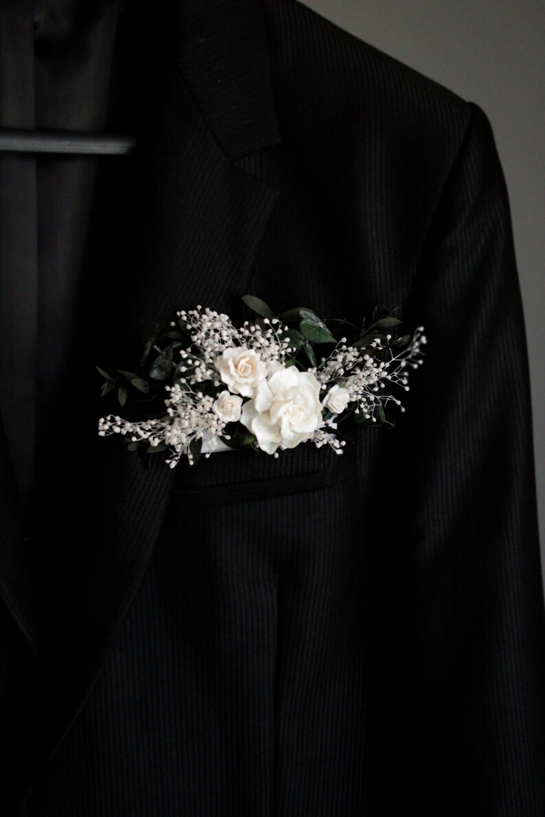 Large white floral pocket boutonniere with eucalyptus leaves, modern groom accessory.