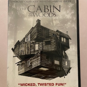 May include: DVD of "The Cabin in the Woods" with a surreal image of a multi-level cabin in a forest setting. The cover includes the text "DVD + DIGITAL COPY + ULTRAVIOLET" and a quote: "WICKED, TWISTED FUN!"