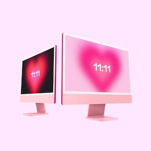 May include: Two pink desktop computers with white screens displaying a pink heart with the number 11:11 in white text.