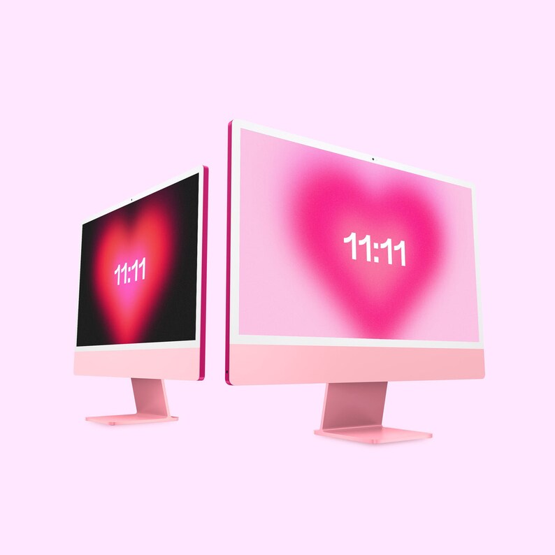 May include: Two pink desktop computers with white screens displaying a pink heart with the number 11:11 in white text.