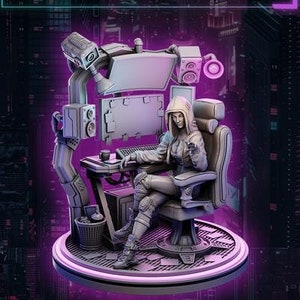 May include: A detailed figurine of a woman in a hooded jacket, seated at a futuristic desk with computer screens and speakers. The text "ADA, the Cyber Sentinel" is displayed. The figure is on a circular platform with a purple glow, set against a cityscape.