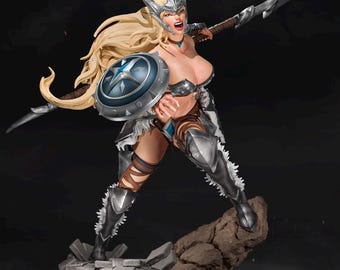 May include: A detailed figurine of a female warrior in silver armor, holding a spear and shield. The warrior has long blonde hair, a helmet, and is posed on a rocky base. The shield is blue with a white star design.