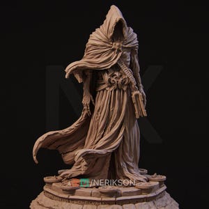 May include: A detailed sculpture of a robed figure with a hooded cloak, holding a book. The figure has an ornate belt and is standing on a detailed base. The sculpture is a neutral tan colour and has a dark background.