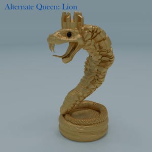 May include: A gold-coloured sculpture of a snake wearing a crown, labelled "Alternate Queen: Lion." The snake is coiled at the base and has an open mouth with fangs. The crown sits atop the snake's head.
