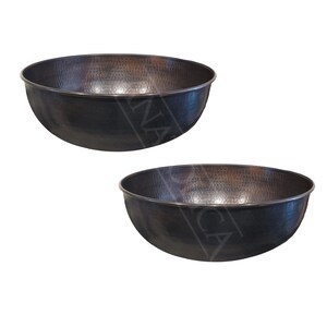 May include: Two large, round, hammered copper bowls. The bowls are dark brown in color and have a slightly textured surface.