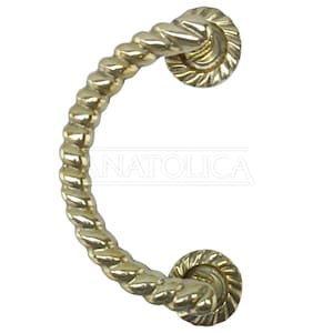May include: A gold-toned, twisted rope-style door pull with two round, decorative end pieces.