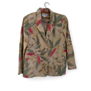 May include: Tan blazer with a botanical leaf pattern in shades of green, red, and brown. The blazer has two buttons and two front pockets. The label reads "Alfred Dunner".