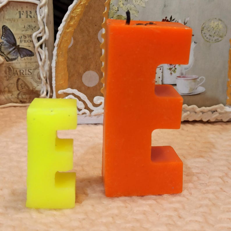 Letter candles in two sizes, yellow small E and orange large E.