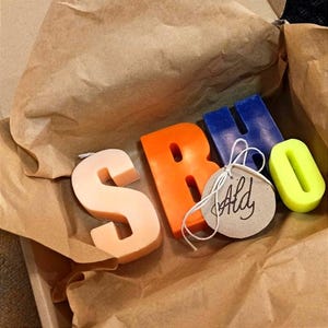 Letters candles of different colors in a box.