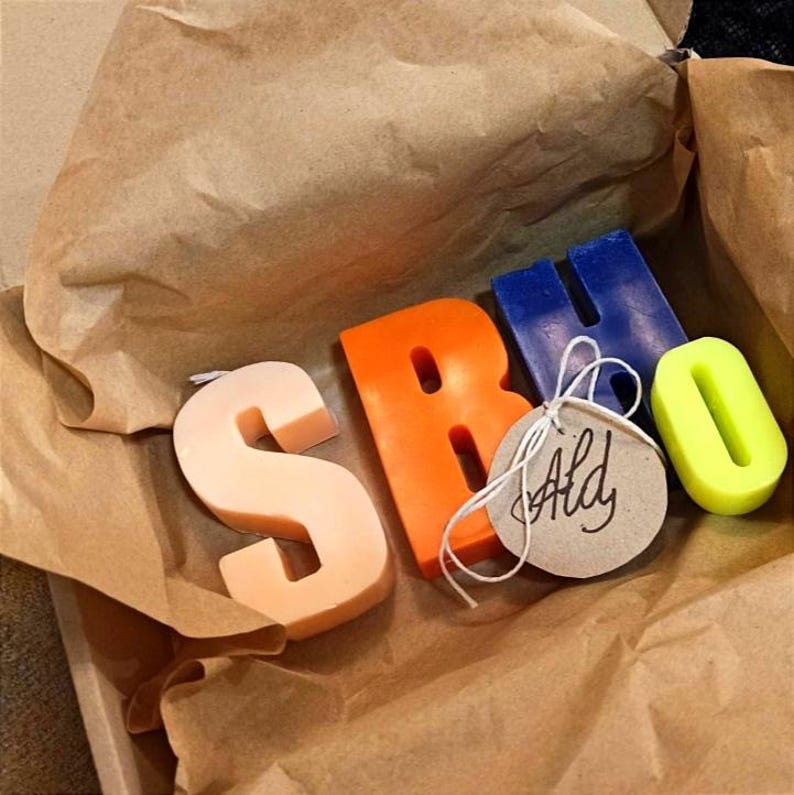 Letters candles of different colors in a box.