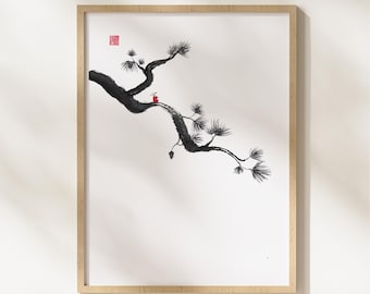 May include: A framed art print with a minimalist ink wash painting of a pine branch. The black branch with detailed needles extends across a white background. A small red accent is present, and the frame is a light wood colour.