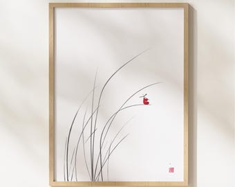 May include: Minimalist art print featuring a delicate ink illustration of tall grass with a small red accent. The artwork is framed in a light wood frame, creating a serene and natural aesthetic. The print has a white background and a small red stamp.