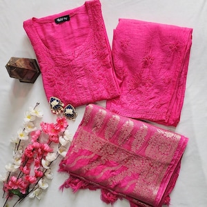 May include: A pink embroidered kurta set with a matching dupatta. The kurta and pants have floral embroidery, and the dupatta has a gold and pink paisley design.