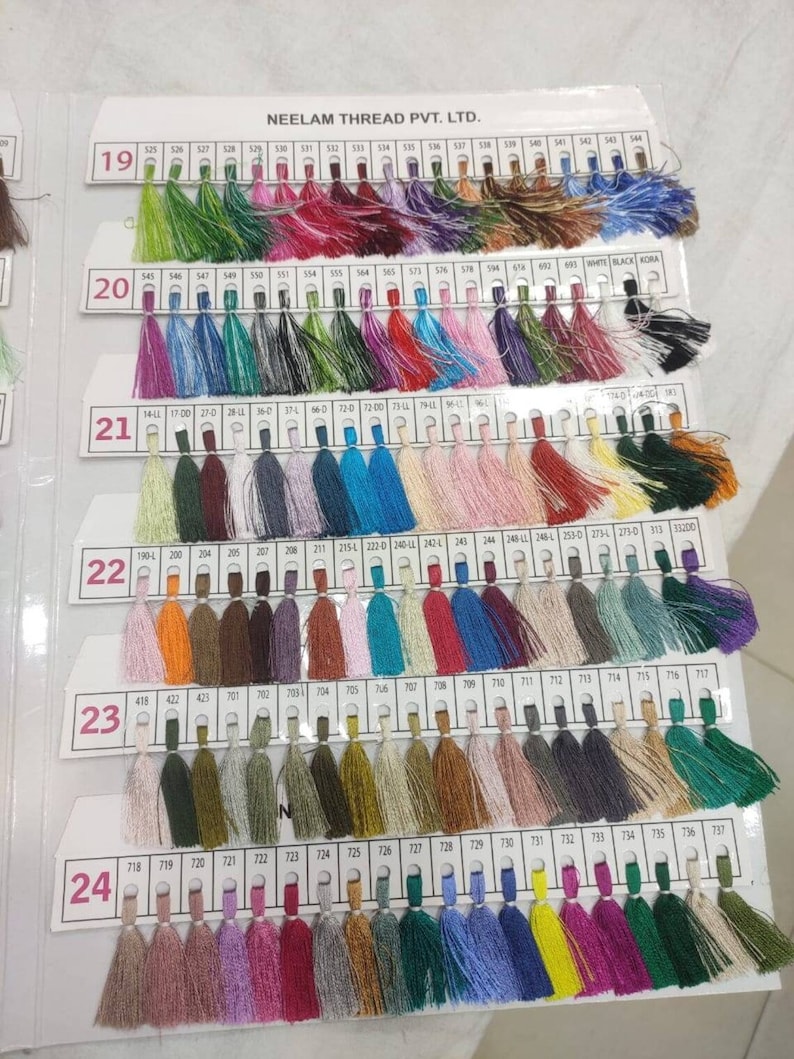 May include: A color chart of thread samples, with each color labeled with a number. The chart is divided into rows, with each row labeled with a number from 19 to 24. The chart is made by Neelam Thread Pvt. Ltd.