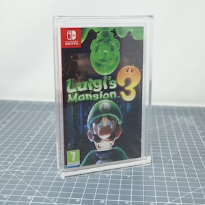 May include: A clear plastic case with a Nintendo Switch game inside. The game is Luigi's Mansion 3 and features a green ghost and Luigi on the cover. The game is rated 7 by the ESRB.