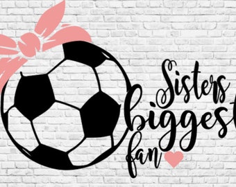 May include: Black and white soccer ball with a pink bandana on top. Text reads "Sisters biggest fan" with a pink heart.