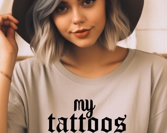 May include: A light gray t-shirt with the text "my tattoos don't like you either" printed in black.