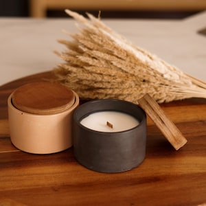 Soy wax candle in a handmade concrete pot with a wooden lid