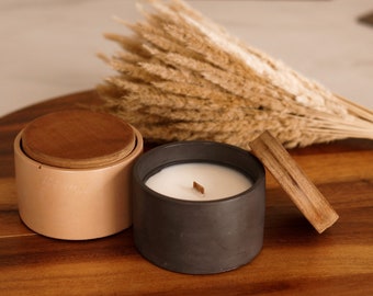 Soy wax candle in a handmade concrete pot with wood cover