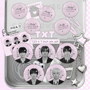 May include: A collection of TXT themed merchandise including circular pins with portraits and names, a sticker sheet, and a metal keychain with star and heart charms. The set features 1.25 and 1 inch pins in a light purple color palette with polka dot patterns.