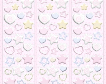 May include: A sticker sheet featuring three vertical columns of repeating pastel-colored heart and star shapes in shades of pink, cream, and light blue. The designs include solid filled shapes and outlined borders on a light pink background with tiny dots.