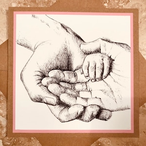 May include: A black and white ink drawing of three hands holding each other. The hands are drawn in a realistic style and the drawing is framed with a pink border.