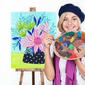 May include: A woman wearing a blue beret paints a floral still life on a canvas. She holds a paint palette with various colors and a paintbrush in her hand.