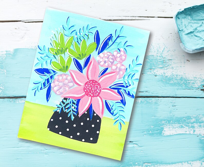 May include: A painting of a bouquet of flowers in a black and white polka dot vase. The flowers are pink, green, and blue. The background is a light blue.