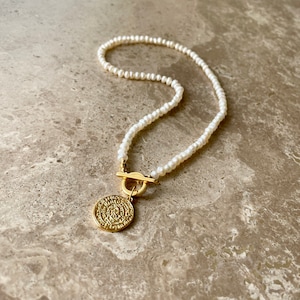 Pearl toggle clasp necklace with gold coin pendant