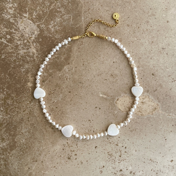 Pearl choker with shell heart charms