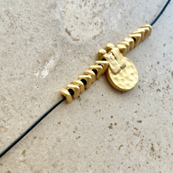 Cord necklace with rustic gold disc pendant
