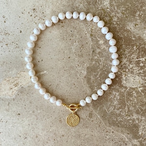 Statement pearl necklace with gold coin pendant
