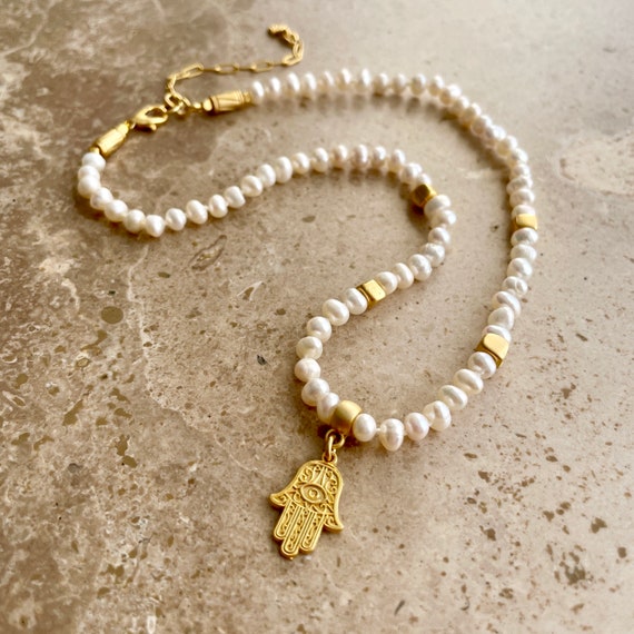 Dainty pearl necklace with gold beads and hamsa charm