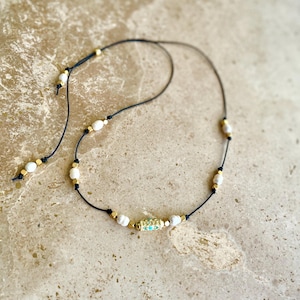On trend adjustable cord charm necklace with love amulet talisman and freshwater cultured pearls. Choice of 3 colours.