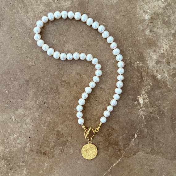 Freshwater pearl necklace with gold medallion charm