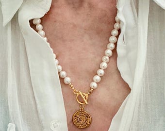 Freshwater pearl necklace with gold medallion charm