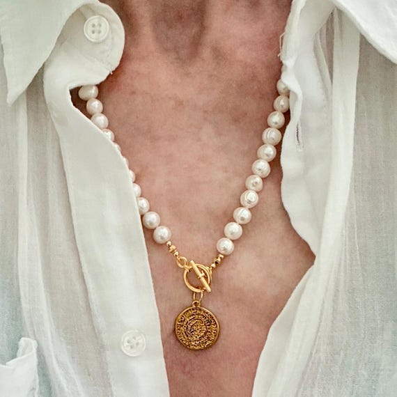 Freshwater pearl necklace with gold medallion charm