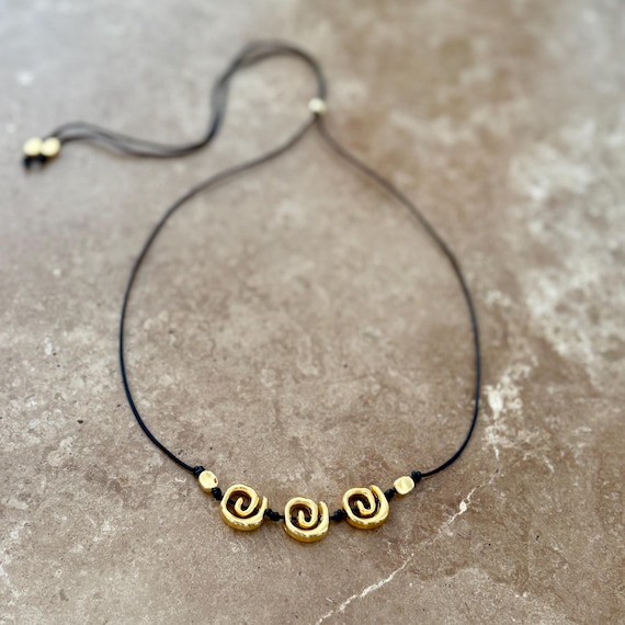 Leather cord gold spirals necklace