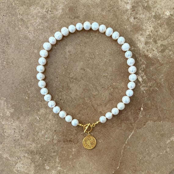 Statement pearl necklace with gold coin pendant