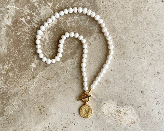 Pearl necklace with gold medallion charm