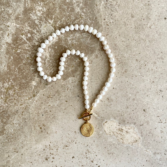 Freshwater pearl necklace with gold medallion charm