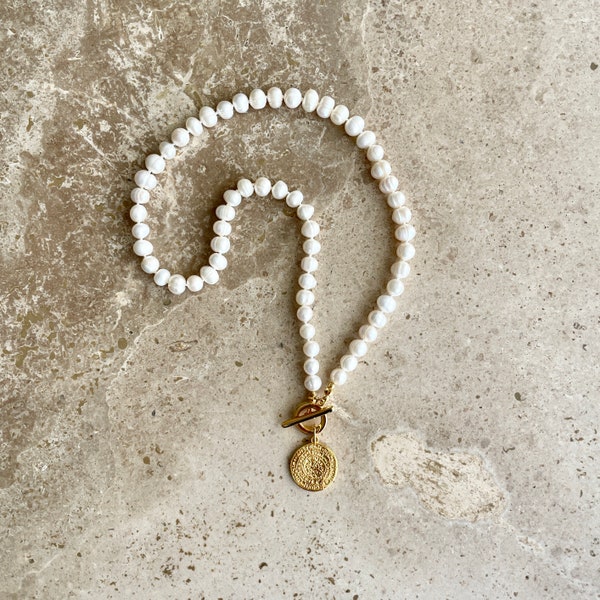 Pearl necklace with gold medallion charm